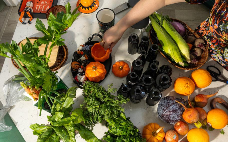 Lynzi Judish organizes containers that will hold some of her produce in her Halloween-themed fridge. 