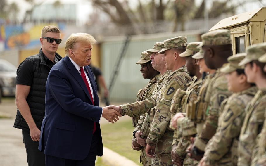 Former President Donald Trump shakes hands with members of the National Guard on the U.S.-Mexico border.