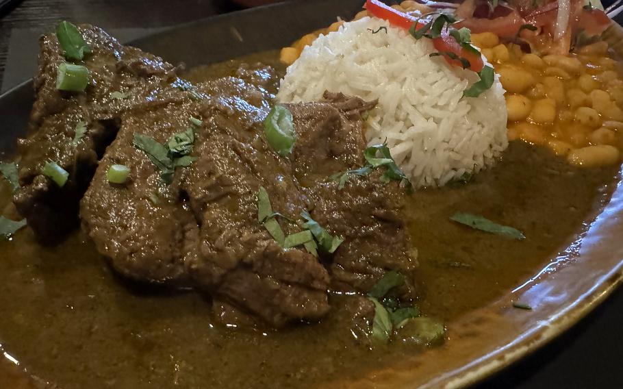 An entree at Mi Peru in Darmstadt is this seco de carne, a beef roast braised in a spicy, aromatic beer sauce, refined with garlic, pepper, cumin and coriander, and served with rice and juicy beans.