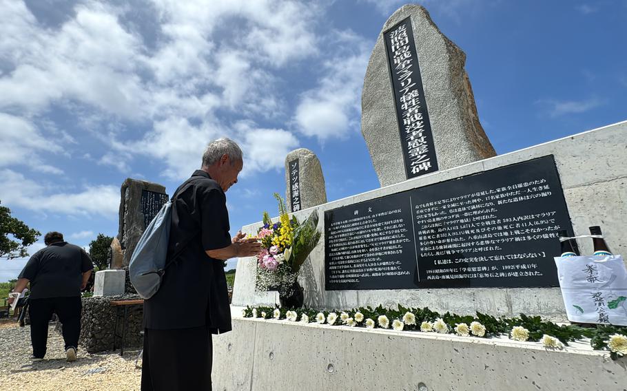 A man prays front of a new monument commemorating wartime malaria victims on Hateruma Island, Japan, on June 15, 2024.