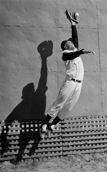 New York Giants center fielder Willie Mays leaps high to snare a ball near the outfield fence at the Giants' Phoenix spring training base, Feb. 29, 1956. Mays, the electrifying “Say Hey Kid” whose singular combination of talent, drive and exuberance made him one of baseball’s greatest and most beloved players, has died. He was 93. Mays' family and the San Francisco Giants jointly announced Tuesday night, June 18, 2024, he had “passed away peacefully” Tuesday afternoon surrounded by loved ones.