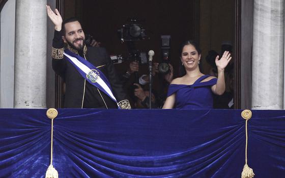 FILE - El Salvador's President Nayib Bukele and first lady Gabriela Roberta Rodríguez wave from a balcony after he was sworn in for a second term, in San Salvador, El Salvador, June 1, 2024.  Known for his heavy-handed crackdown on street gangs, threatened to use similar tactics against price gougers, Bukele said in a speech late Friday, July 5. (AP Photo/Salvador Melendez, File)