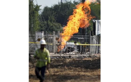 An above-ground valve continues to burn three days after after a vehicle drove through a fence along a parking lot and struck the site, Wednesday, Sept. 18, 2024, in La Porte, Texas. (Jason Fochtman/Houston Chronicle via AP)