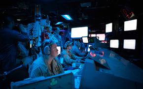 Sailors assigned to the Arleigh Burke-class guided-missile destroyer USS Carney stand watch in the ship’s combat information center during an operation to defeat a combination of Houthi missiles and unmanned aerial vehicles in the Red Sea, Oct. 19, 2023.