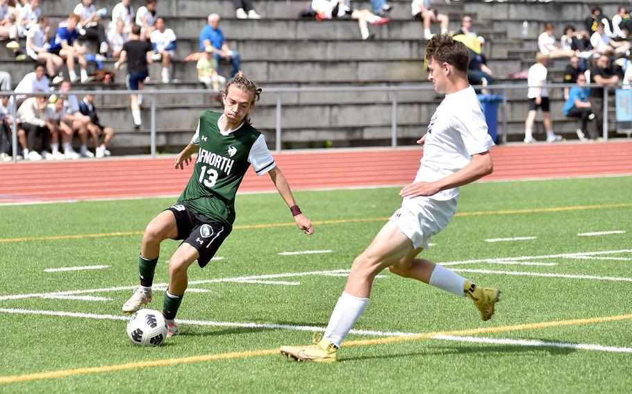 AFNORTH senior Juan Antonio Rey cuts back as Ansbach midfielder Lucas Rudy defends during the Division III boys title match at the DODEA European championships on May 23, 2024, at Ramstein High School on Ramstein Air Base, Germany.