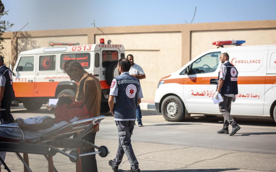 Ambulances from Egypt wait to pass through the Rafah border crossing to transport seriously wounded Palestinians on Wednesday, Nov. 1, 2023.