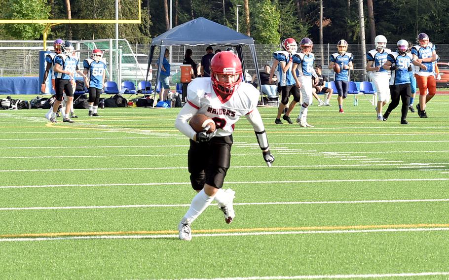 Kaiserslautern wide receiver Logan Bell runs with the ball after catching a ball in the flat during the Raiders' Aug. 25, 2023, scrimmage against the Royals at Ramstein High School on Ramstein Air Base, Germany.