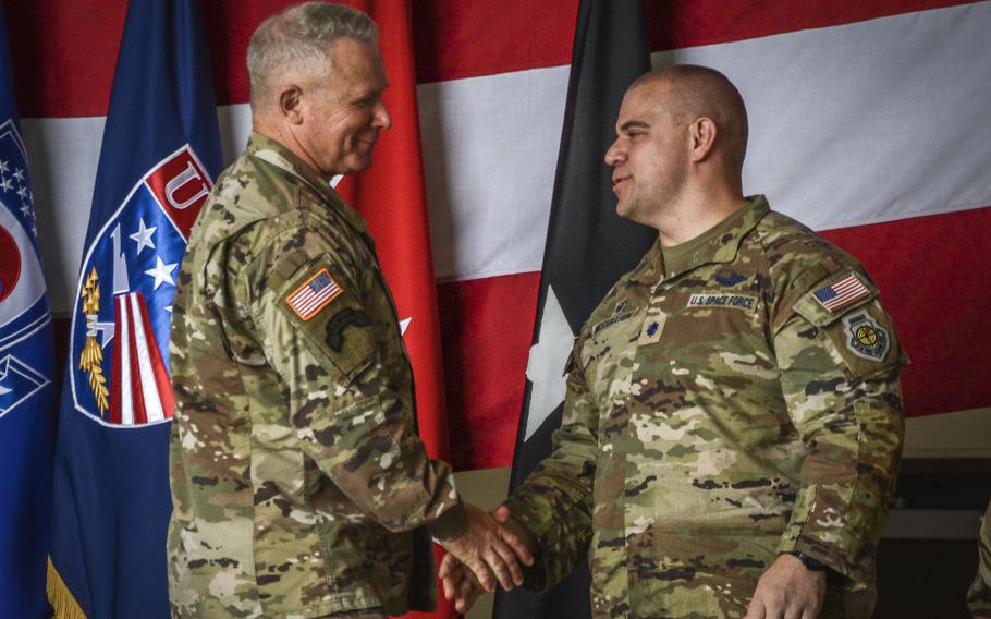 U.S. Forces Korea commander Gen. Paul LaCamera shakes hands with  Lt. Col. Joshua McCullion, outgoing commander of Space Forces Korea at Osan Air Base, South Korea, July 12, 2024. 