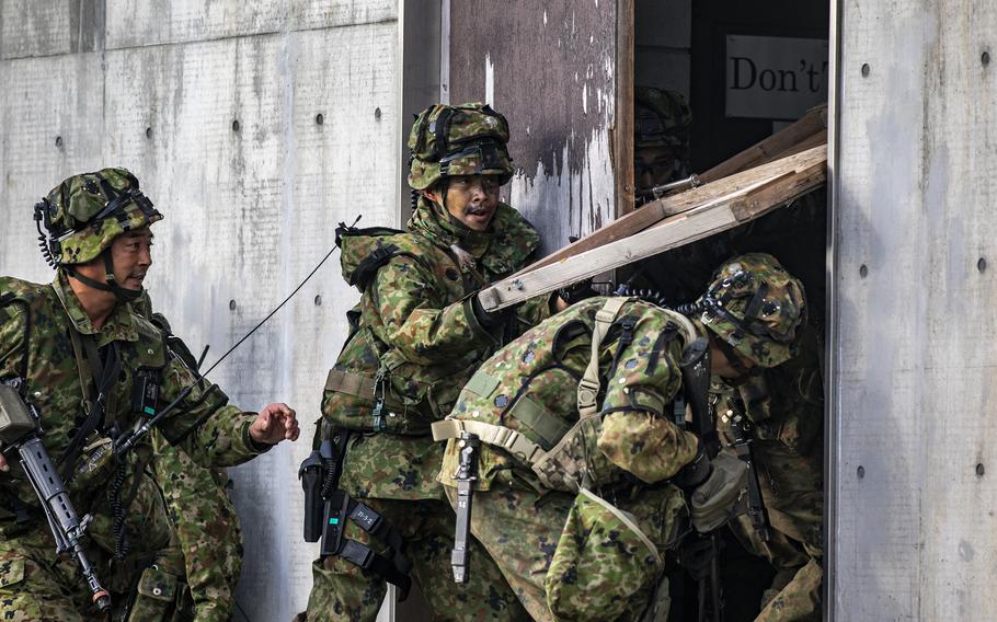 Members of the Japan Ground Self Defense Force charge into the fight during a training assault for Orient Shield 2018. 