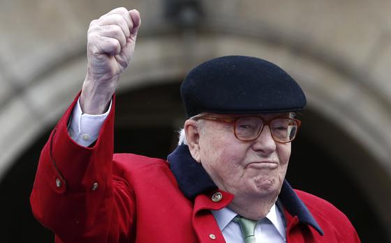 FILE - Former far-right National Front party leader Jean-Marie Le Pen clenches his fist at the statue of Joan of Arc, Monday May 1, 2017, in Paris. (AP Photo/Kamil Zihnioglu, File)