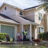 A maintenance worker in 2019 for Balfour Beatty Communities, a private company that manages military housing, power washes the driveway of a home at Marsh Cove, a military residential community at Naval Station Mayport, Fla.