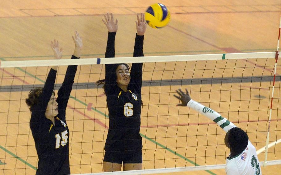 Kubasaki's Viola Wray spikes against the double block of Kadena's Marina Sawyer and Rylie Artuyo during Tuesday's Okinawa volleyball match. The Dragons beat the Panthers in straight sets for the 10th time this season.