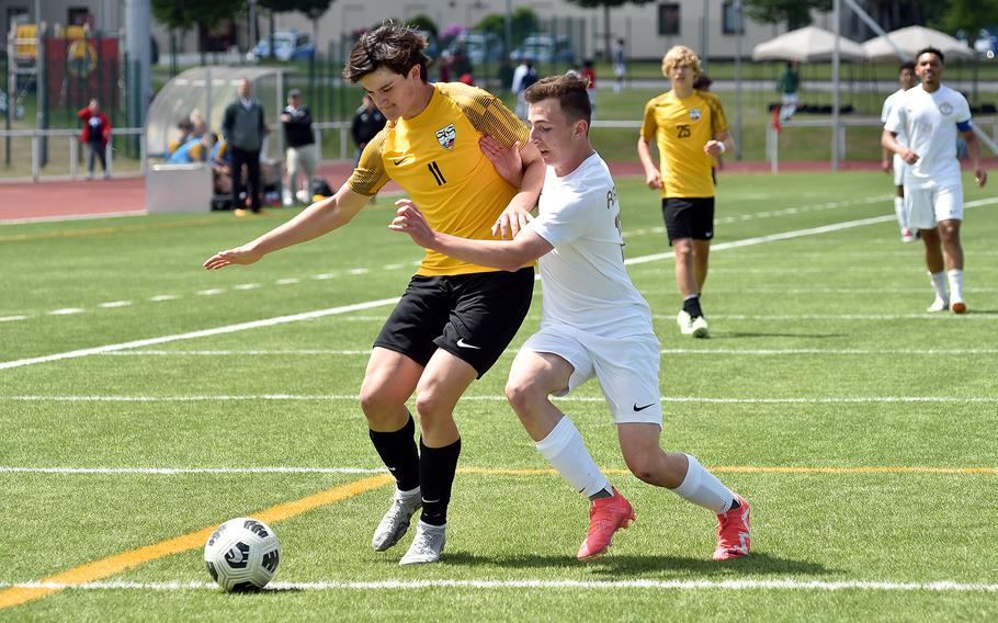 Stuttgart defender Gabe Tamez muscles off Ramstein midfielder Kai Woodstock from the ball in a Division I semifinal of the DODEA European soccer championships May 22, 2024, at Kaiserslautern High School in Kaiserslautern, Germany.