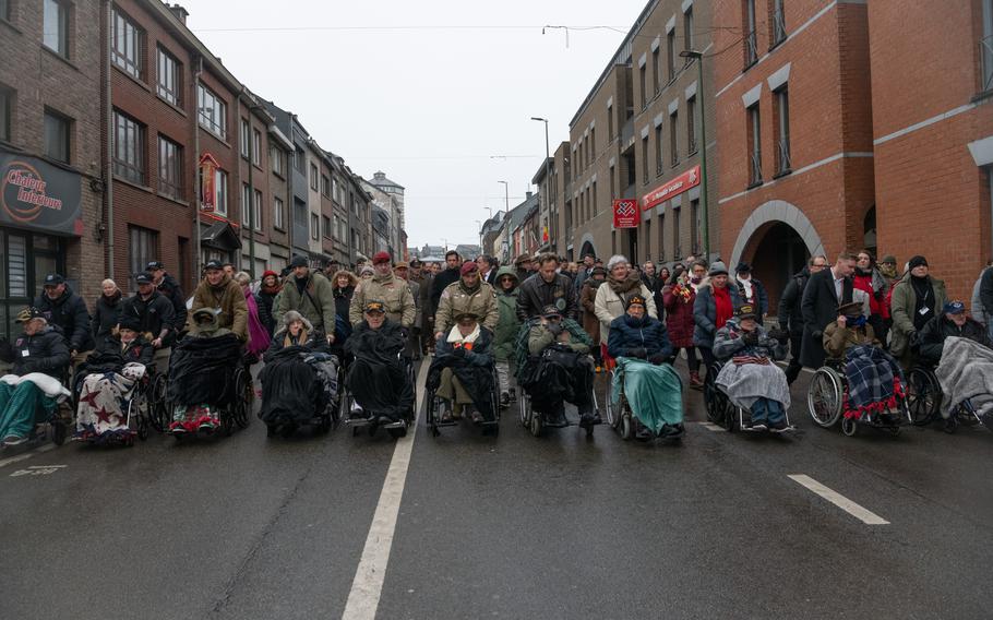 U.S. World War II veterans parade through the streets