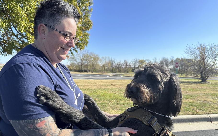 Heather O’Brien holds her labradoodle service dog.