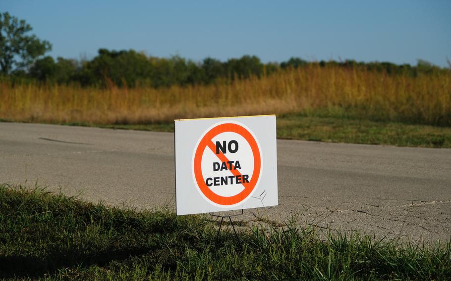 A sign posted beside a road that reads no data center.