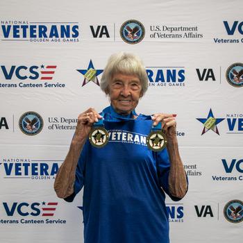 Army veteran Betty St. John shows off the latest additions to her medal collection at the 2024 National Veterans Golden Age Games.