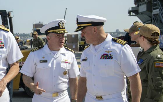 Capt. Daryle Cardone, left, commander of the USS Ronald Reagan, greets Capt. Tim Waits, skipper of the USS George Washington, at Naval Air Station North Island, Calif., July 24, 2024.