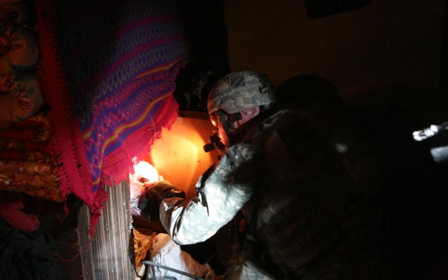 Capt. Eric Melloh, 30, of Huntsville, Texas and commander of Company A, 1-30th Infantry, 2nd Brigade, 3rd Infantry Division, searches the home of a man suspected of helping insurgents direct mortar fire at Forward Operating Base Murray in Iraq’s Arab Jabour district southeast of Baghdad.