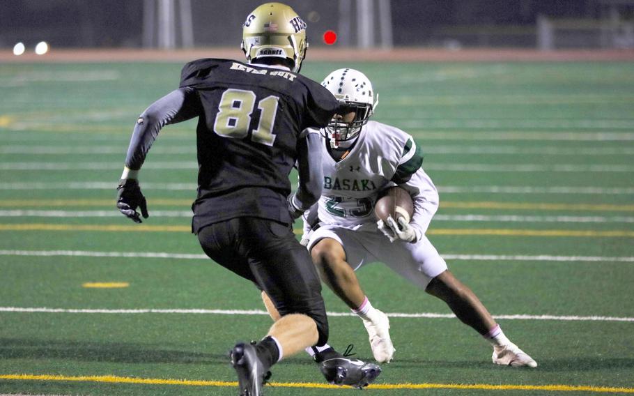 Humphreys' William Dales rushes up to meet Kubasaki running back A.J. Sablan.