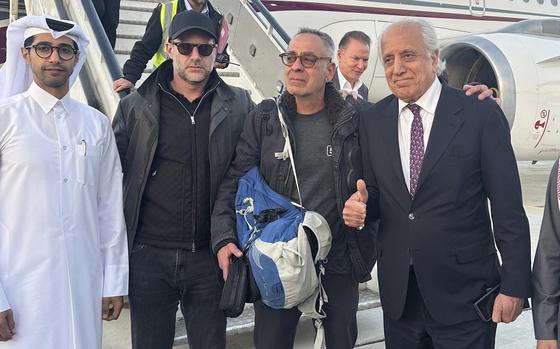 In this handout photo released by Qatar Ministry of Foreign Affairs, George Glezmann, center, poses with Adam Boehler, second left, and Zalmay Khalilzad, second right, and Qatari diplomats in Kabul, Afghanistan, Thursday, March 20, 2025, before departing to Doha, Qatar. (Qatar Ministry of Foreign Affairs via AP)