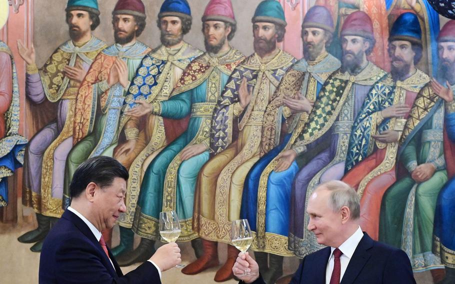 Russian President Vladimir Putin and China’s President Xi Jinping make a toast during a reception following their talks at the Kremlin in Moscow on March 21, 2023.