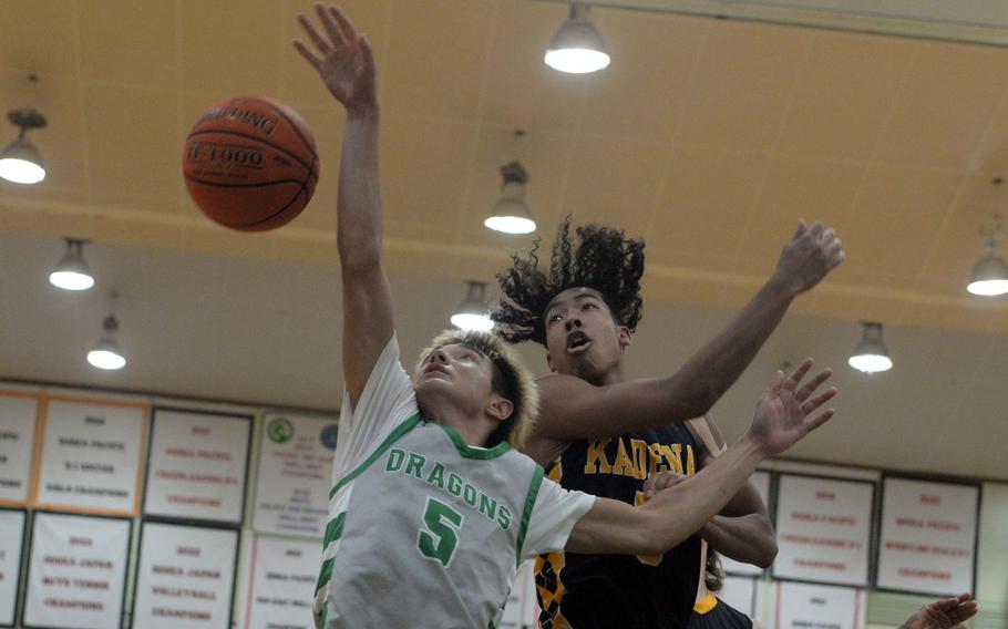 Jin Inman and Cory Tripp battle for the ball.