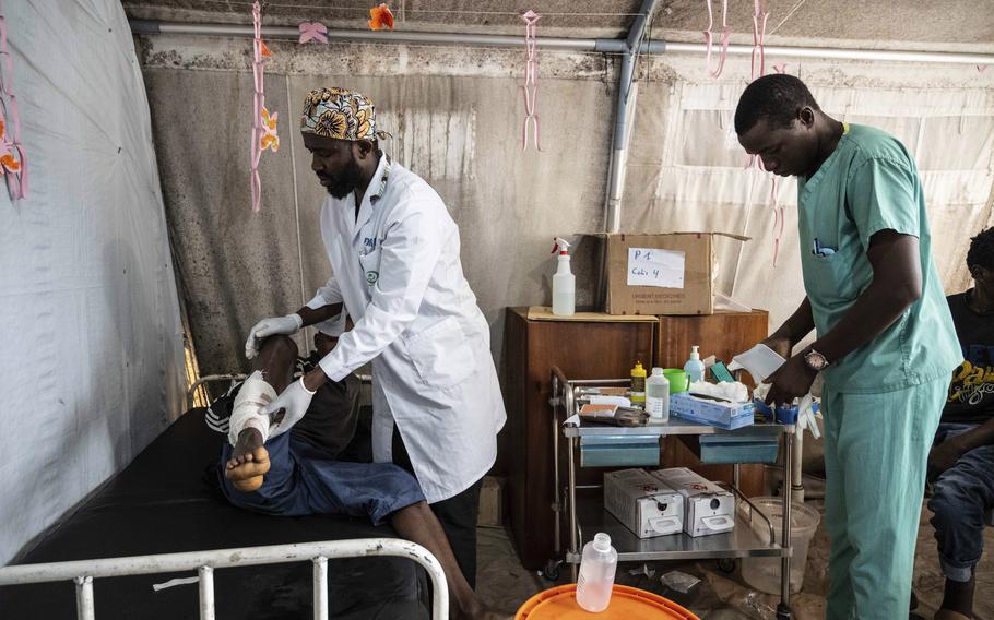 Medics treat a man wounded