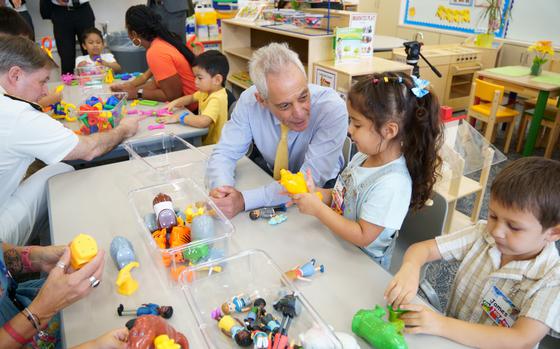 U.S. Ambassador to Japan Rahm Emanuel sits with students at Yokosuka Primary School, Yokosuka Naval Base, Japan, on Sept. 4, 2024, the first day of the Department of Defense Education Activity's new universal pre-kindergarten program. 
