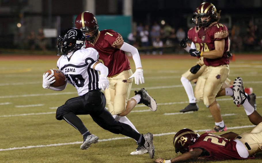 Zama's Kaisei Muta cuts around left end against Matthew C. Perry during Friday's DODEA-Japan football game. The Trojans won 50-0.