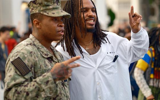 Social media food influencer Keith Lee poses with a sailor during Friendship Day at Yokosuka Naval Base, Japan, Oct. 6, 2024. 