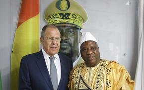 In this photo released by Russian Foreign Ministry Press Service, Russian Foreign Minister Sergey Lavrov, left, and Guinea's foreign minister Morissanda Kouyate pose for a photo near a portrait of Guinea's President Mamadi Doumbouya during their meeting in Conakry, Guinea, Monday, June 3, 2024. Russian Foreign Minister Sergey Lavrov arrived Monday in Guinea on his latest visit to West Africa, where coups and growing discontent with traditional allies like France and the United States have contributed to some countries' shift towards Moscow. (Russian Foreign Ministry Press Service via AP)