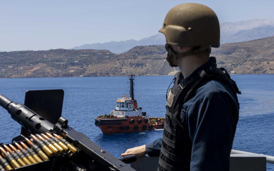 Petty Officer 3rd Class Connor Hall mans a gun mount as USS Wasp pulls in to Souda Bay, Greece, July 8, 2024, for a port call.