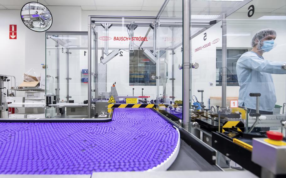 In this March 2021 photo provided by Pfizer, a technician works on a line for packaging preparation for the Pfizer-BioNTech COVID-19 vaccine at the company's facility in Puurs, Belgium. 