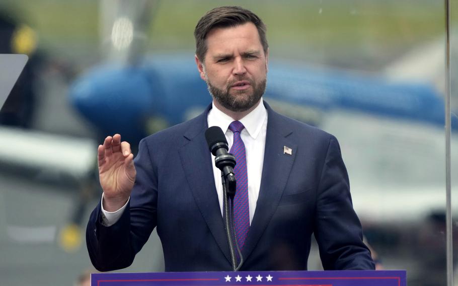 JD Vance stands at a podium and speaks at a campaign rally.