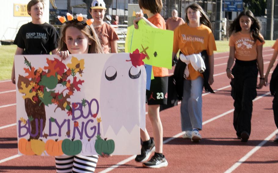 "Boo bullying!" A Yokota Middle School student sends a message during an anti-bullying walk at Yokota Air Base, Japan, Oct. 26, 2023. 