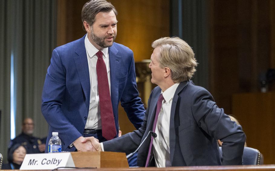 Vice President J.D. Vance, left, shakes hands with Under Secretary of Defense nominee on Wednesday, Feb. 12, 2025, before a Senate Armed Services Committee hearing to examine the nomination of Colby to be Under Secretary of Defense for Policy in Washington.