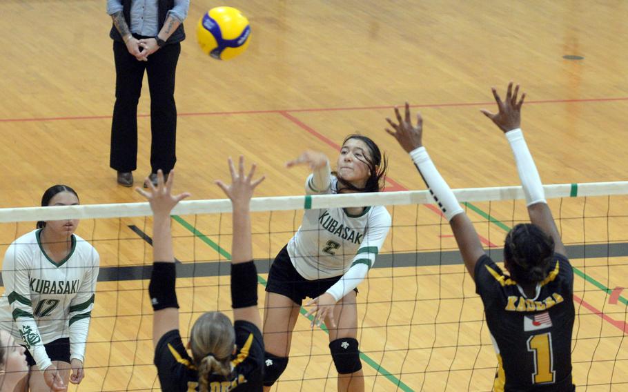 Kubasaki's Runa Holladay spikes against Kadena's Jenna Cook and Liza Young during Tuesday's Okinawa girls volleyball match. The Panthers won in five sets.