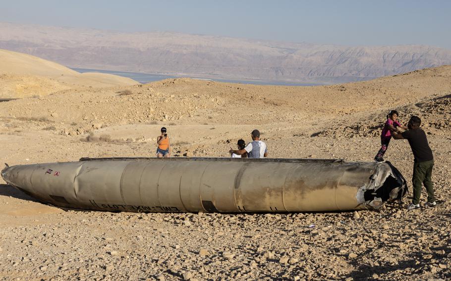 People visit the remains of an Iranian missile near the Dead Sea on Oct. 3, 2024.