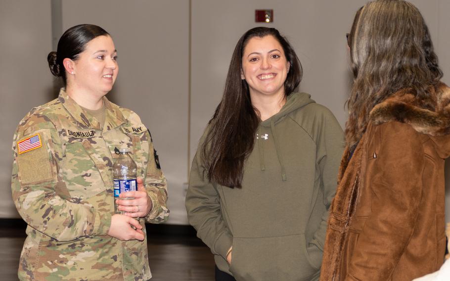 Soldier talks with two women