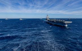 NORFOLK, Va. - The world's largest aircraft carrier, USS Gerald R. Ford (CVN 78), sails in formation with the Arleigh Burke-class guided missile destroyers USS Winston Churchill (DDG 81), USS Mitscher (DDG 57), USS Mahan (DDG 72), USS Bainbridge (DDG 96), and USS Forrest Sherman (DDG 98) in the Atlantic Ocean, Nov. 12, 2024. The Gerald R. Ford Carrier Strike Group is underway in the Atlantic Ocean completing Group Sail. Group Sail is the first at-sea integrated phase training event during a routine deployment training cycle. It is designed to challenge the Gerald R. Ford CSG s ability to use the capabilities of the USS Gerald R. Ford (CVN 78), USS Winston S. Churchill (DDG 81), Carrier Air Wing (CVW) 8, Destroyer Squadron (DESRON) 2, and embarked Information Warfare team as a cohesive Strike Group to meet Navy and Joint Warfighting requirements that increases warfighting capability and tactical proficiency across all domains. (U.S. Navy photo by Mass Communication Specialist 2nd Class Maxwell Orlosky)