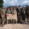 Spokesman for the 101st Airborne Division Lt. Col. Martin Meiners, seventh right, poses for a photo with Dutch reenactors on Thursday, Sept. 12, 2024, in Mesch, Netherlands. The reenactors — including Jan-Thijs Koppen, second left — were dressed as soldiers from the 30th Infantry Division, which liberated the village 80 years ago.