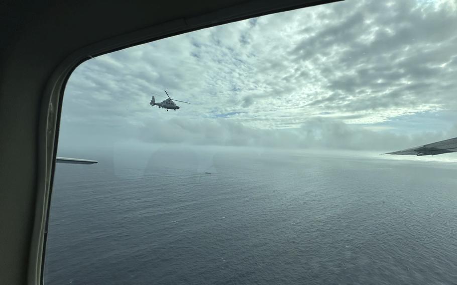 A Chinese military helicopter flies close to a Philippine Bureau of Fisheries and Aquatic (BFAR) aircraft.