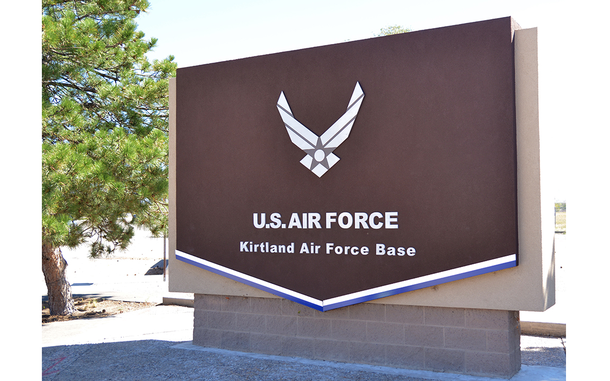 An entrance sign reading “U.S. AIR FORCE” and “Kirtland Air Force Base.”