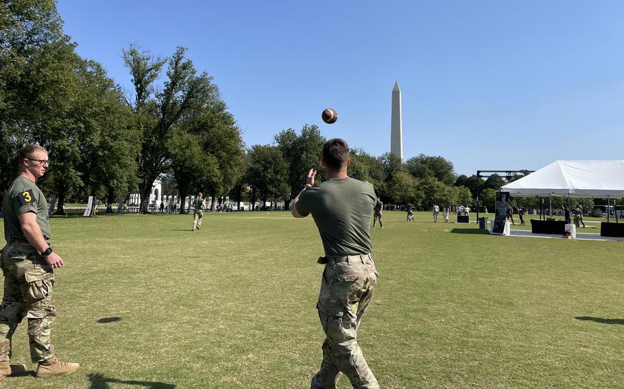 Soldiers from different squads mingle and throw footballs to relax at the National Mall in Washington, D.C., Oct. 12, 2024.