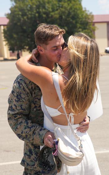 U.S. Marine Corps 1st Lt. David Molz, an intelligence officer assigned to the 15th Marine Expeditionary Unit and a native of New Jersey, kisses his girlfriend at a welcome home reception at Marine Corps Base Camp Pendleton, Calif., on Aug. 10, 2024. 