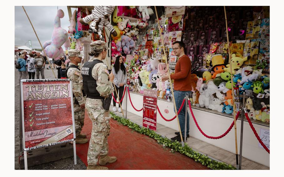 Two U.S. Army Military Police members took a quick break from their rounds to interact with festival vendors at the 63rd Annual German-American Volksfest on Camp Algiers, Grafenwoehr, Germany from August 2-4, 2024. 