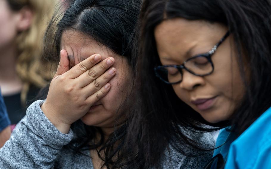 Adriana Rosales, left, is consoled by Therese Badiki on May 7, 2023, as she weeps at a makeshift memorial outside Allen Premium Outlets in Allen, Texas, where a day earlier a gunman killed eight people before being shot dead by police. 