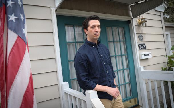 Doug Jackson, pictured on the front porch at his Orlando home on Tuesday, Feb. 25, 2025, is one of the many federal employees caught up in the mass firings initiated by Elon Musk and the Trump administration, having been abruptly fired from his probationary position with the IRS. (Rich Pope, Orlando Sentinel)