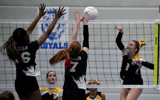 Vicenza senior Maya Fitch hits the ball against American Overseas School of Rome's Gabby Makinwa, left, and Gloria Rose Olivieri during a Division II semifinal match at the DODEA European volleyball championships on Nov. 1, 2024, at Ramstein High School on Ramstein Air Base, Germany.